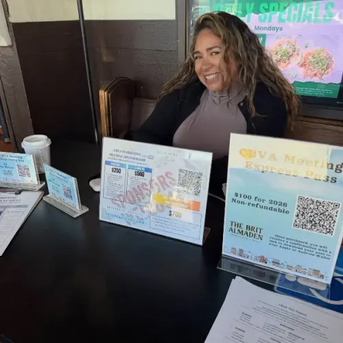 Maria at a Home Pros networking table with flyers